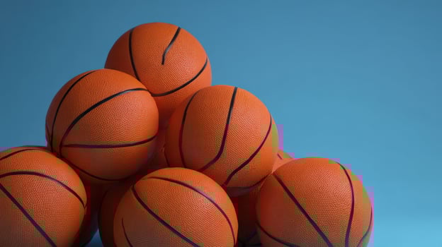 The vibrant stack of basketballs on a blue background showcasing athletic spirit. photo