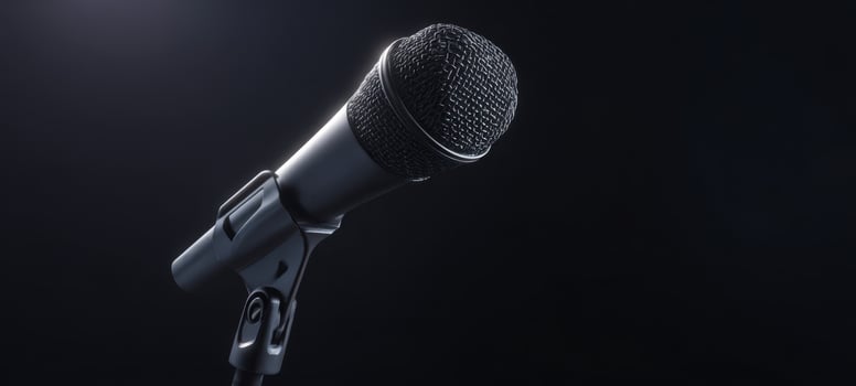 The microphone poised for performance against a dark background. photo