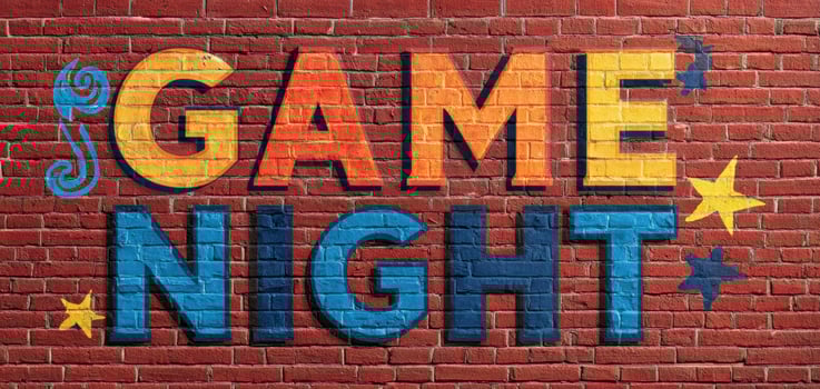 The colorful mural celebrating Game Night on a textured brick wall. photo