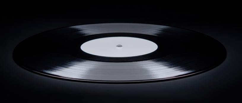 The iconic vinyl record on a sleek black background, showcasing timeless music. photo