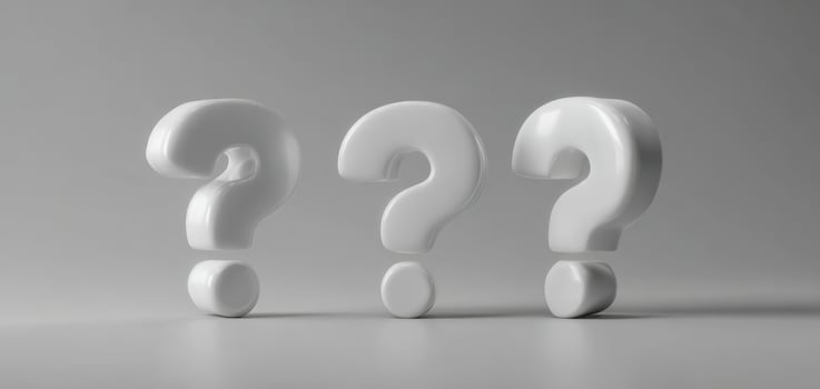 The White Question Marks Representing Curiosity and Inquiry in a Minimalist Setting photo