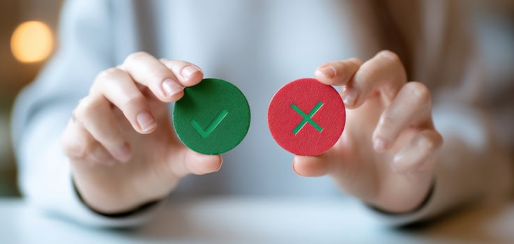 The hands holding green and red decision-making tokens for effective communication photo