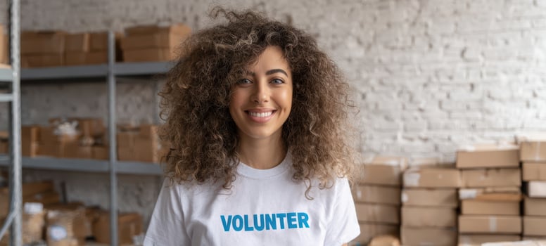The smiling volunteer showcasing dedication and community support in a warehouse setting. photo