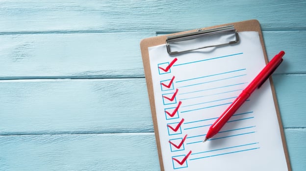 The checklist with red marks on a clipboard for organized planning and task management. photo
