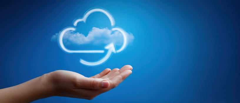 The hand presenting a conceptual cloud storage symbol in a blue sky. photo