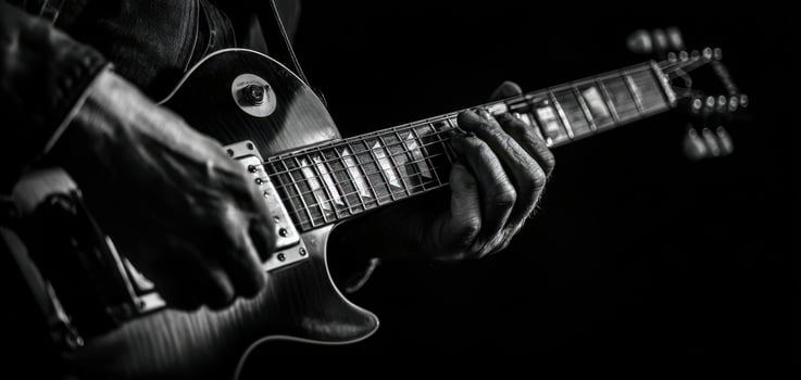 The musician skillfully playing an electric guitar in black and white. photo