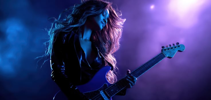 The passionate woman rocking out with an electric guitar on stage. photo
