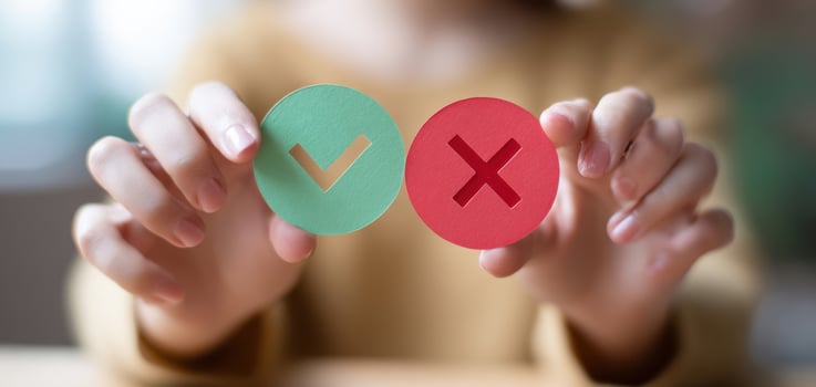 The hands holding green check and red cross symbols for making decisions. photo