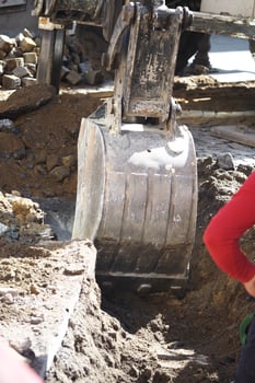 Excavator working on construction site in urban area photo