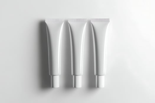 Three empty tubes of cream on a white surface photo