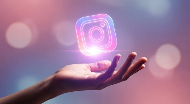 Hand holding glowing instagram logo, representing social media and connection photo