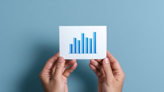 The Hands Holding a Growth Chart on a Soft Blue Background photo