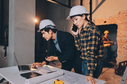 Construction workers reviewing plans together photo
