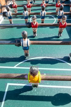 The miniature players of a classic pub game entertainment concept photo