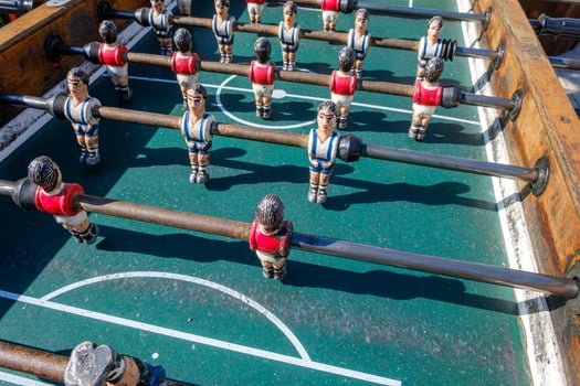 Old table soccer game with red and blue teams nostalgia and childhood concept photo