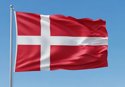 Danish National Flag Waving Against Blue Sky photo