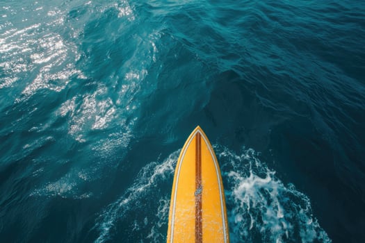 A yellow surfboard is in the water photo