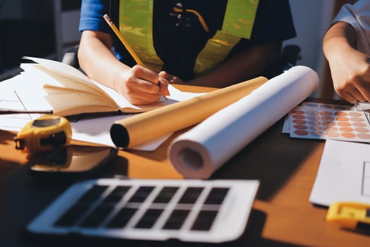 Person drawing with design materials on desk photo