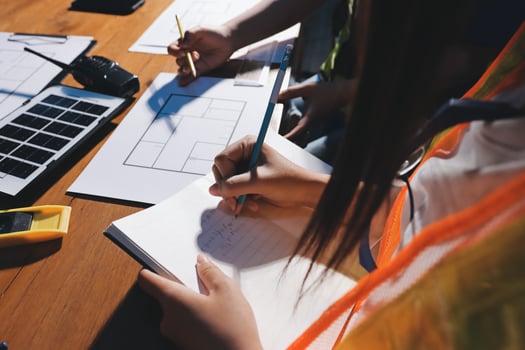 Hands writing notes in a planning session photo
