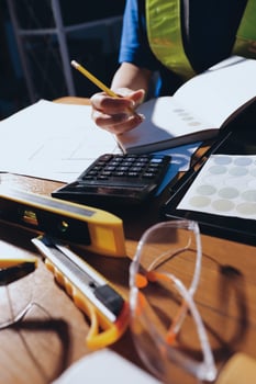 Person calculating with tools on a table photo