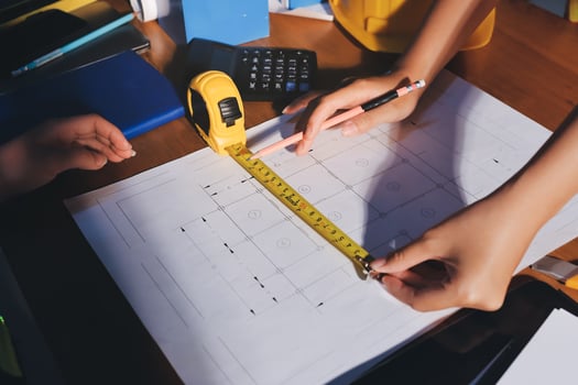 Measuring tape on architectural plans photo
