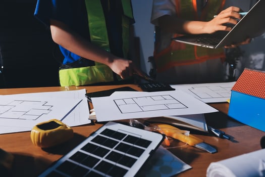 Engineers collaborating on design plans photo