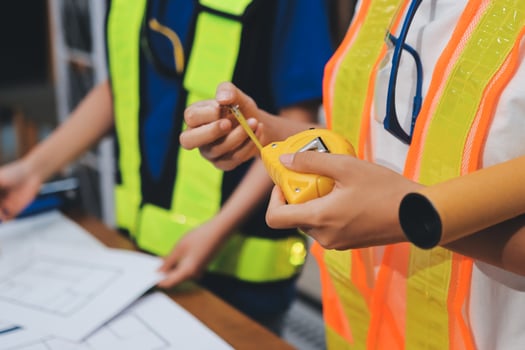 Construction workers measuring with tools photo