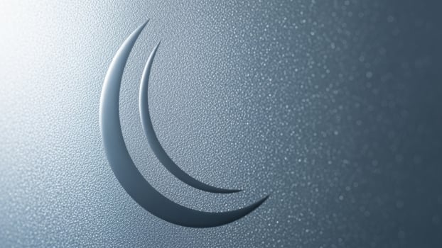 A crescent moon on a shiny surface photo