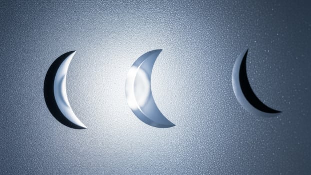 Three crescent shaped lights on a wall photo
