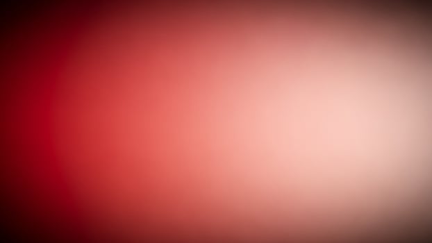A blurry red and black background with a blurred light photo
