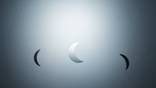 A photo of a wall with three crescent shaped lights
