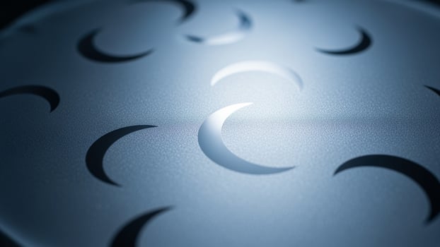 A close up of a metal sphere with many moon phases photo