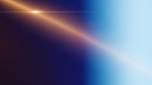 A bright light shining through a blue and orange background photo