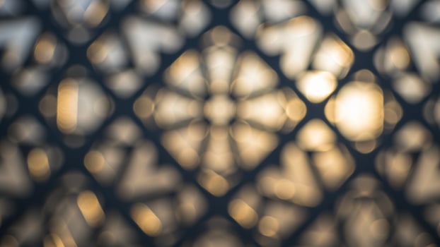 Abstract background of a metal lattice with a sun shining through photo