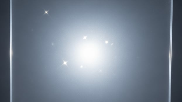 A bright light shining through a dark sky photo