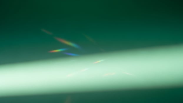 A green light shining on a green background photo