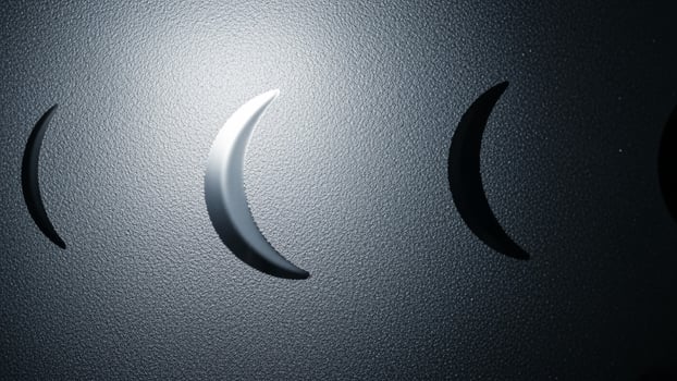 A close up of a metal wall with three crescents photo