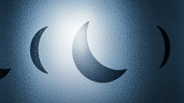 A metal object with three crescent moons on it photo