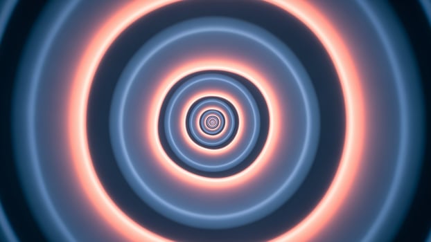A circular light in blue and pink is shown photo