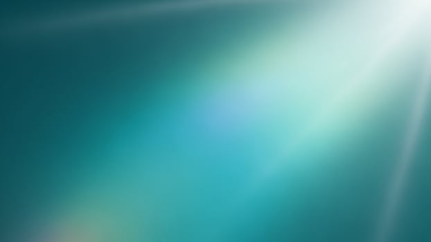 A bright light shining through a blue background photo