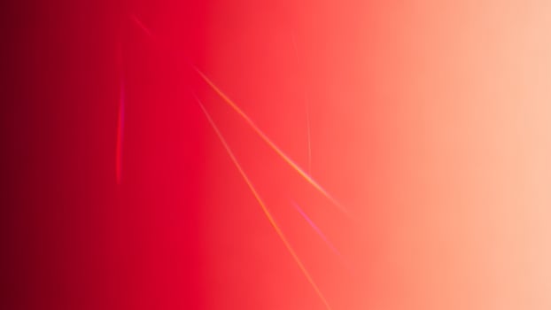 A red and orange background with a bright light photo