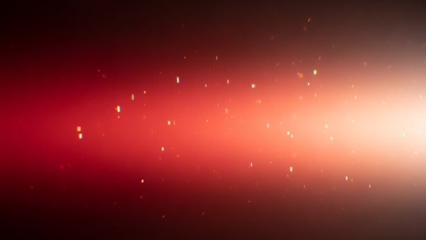 A red and white light is shining in the dark photo