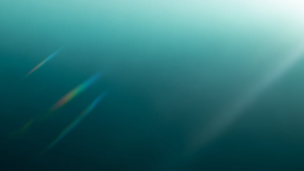 A blue and green background with a sun shining photo