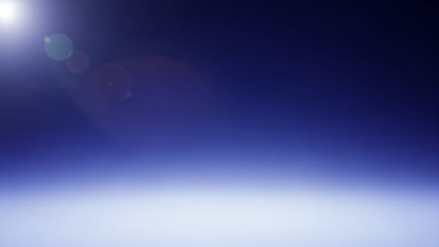 A blue light shines on a white surface photo