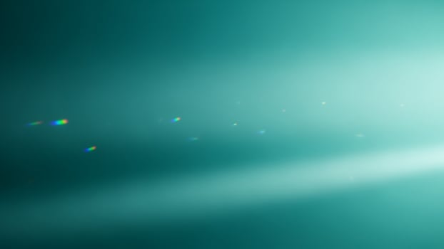 A light beam is shining on a green background photo