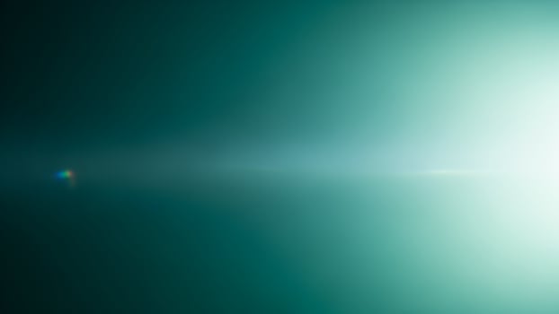 A green light shines through the water photo