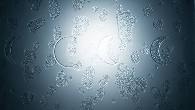 A close up of a metal surface with water droplets photo