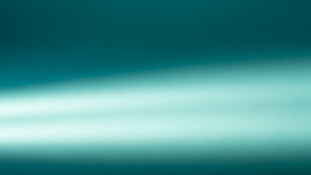A light beam coming from a spotlight on a blue background photo