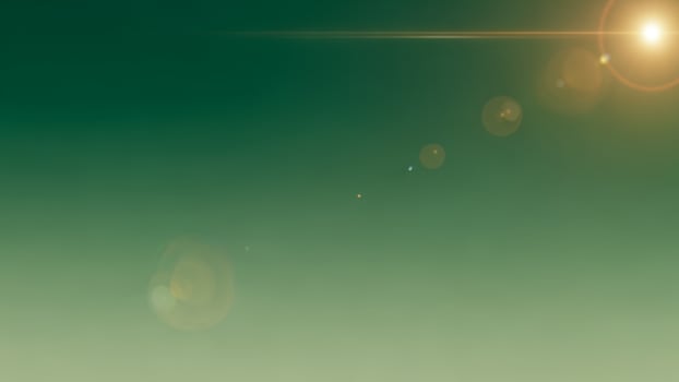 A green background with a sun shining in the sky photo