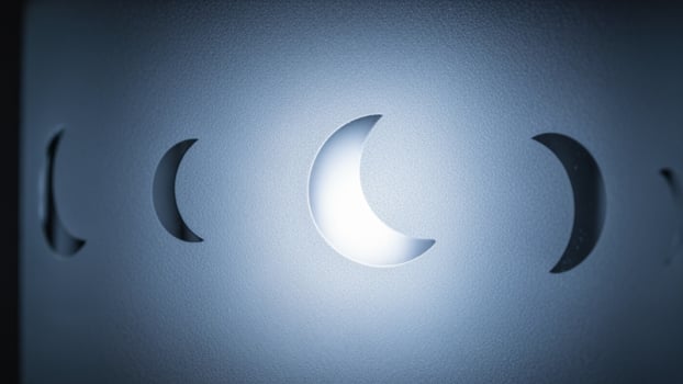 A white wall with a lighted moon photo